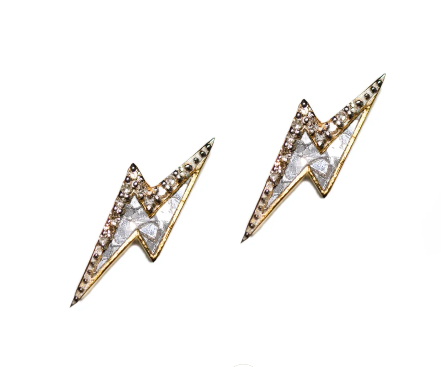 A pair of gold-colored stud earrings in a lightning bolt shape, with silver resin and champagne diamonds.