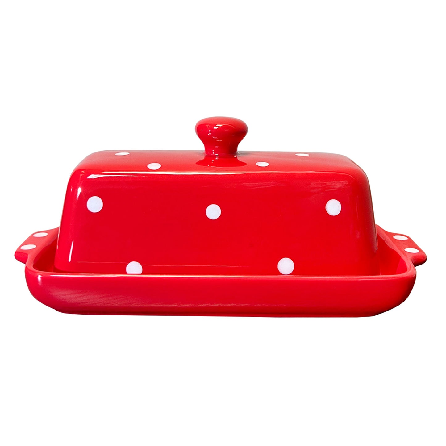 Red ceramic butter dish with white polka dots on a white background