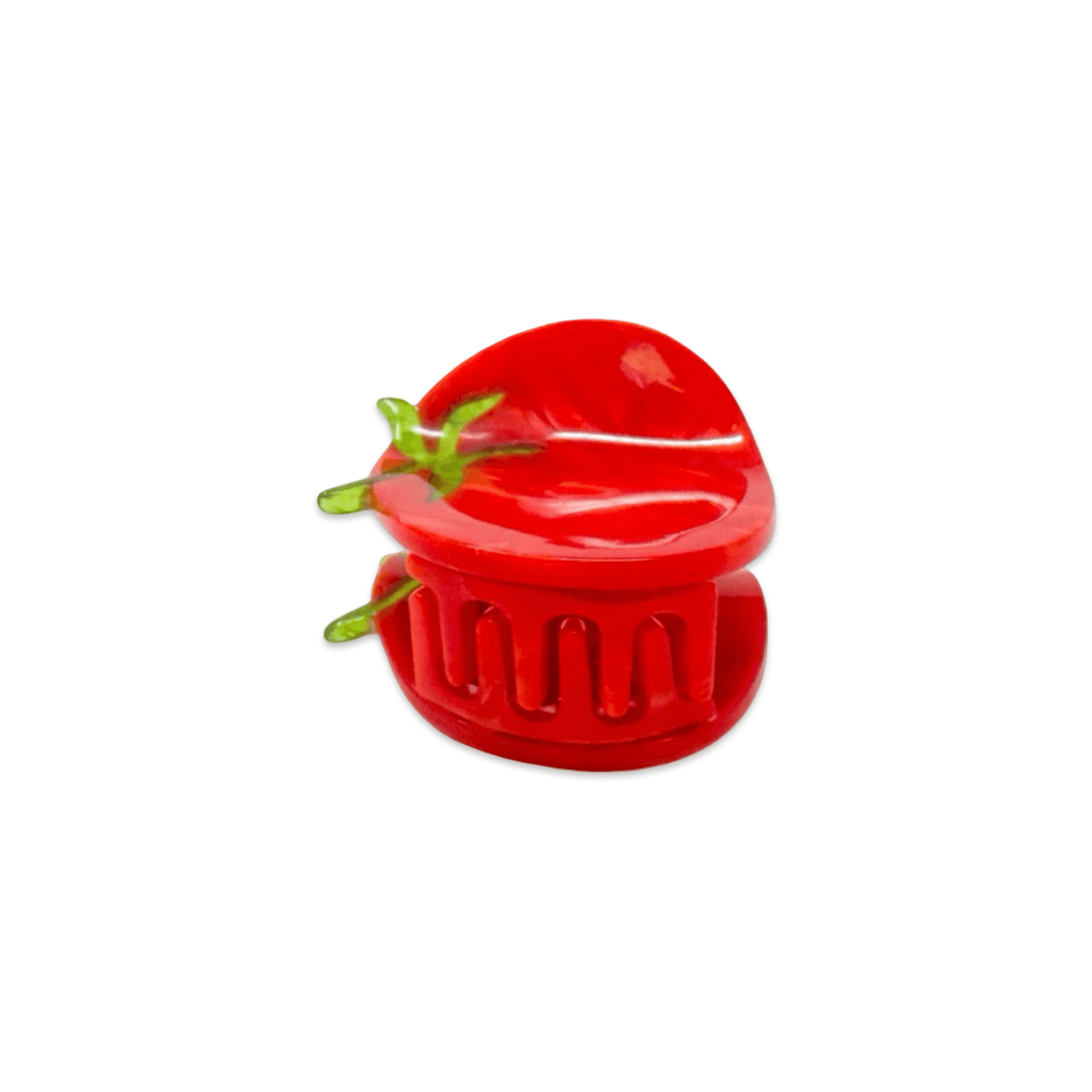 Red plastic tomato-shaped hair-claw on a white background