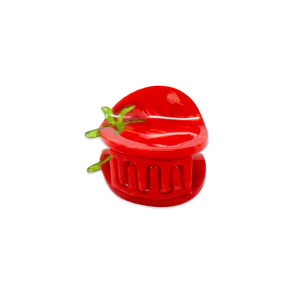 Red plastic tomato-shaped hair-claw on a white background