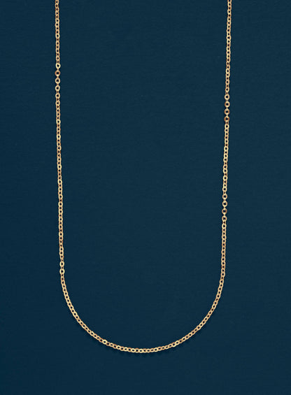 Gold chain necklace on a dark blue background