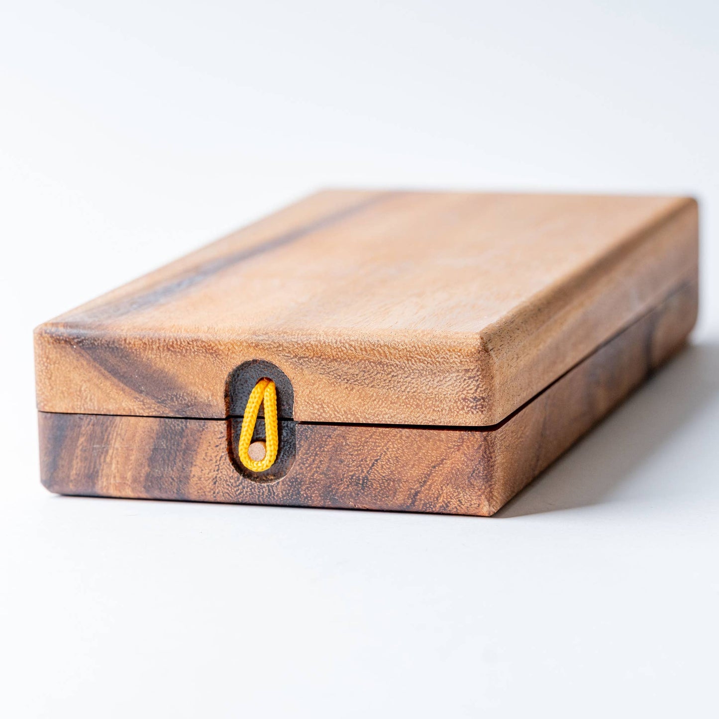 Wooden box with a yellow latch on a white background