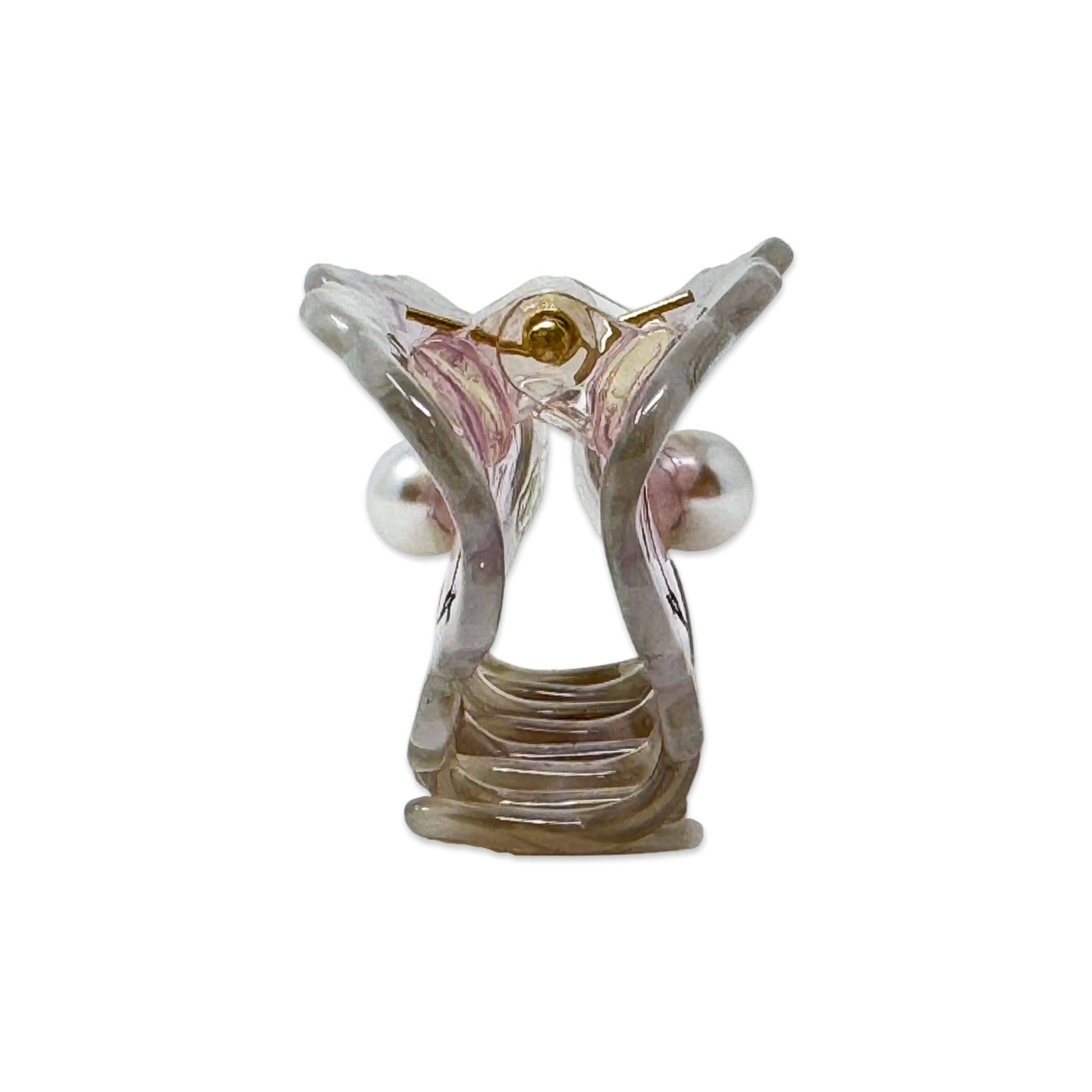 Clear plastic model of a human ear on a white background