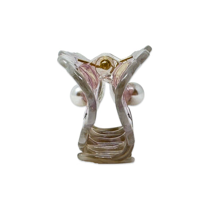 Clear plastic model of a human ear on a white background
