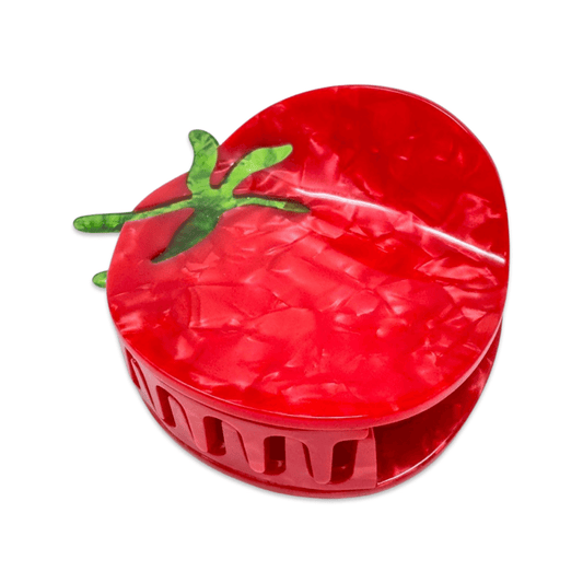 Red tomato-shaped hair claw with green stem on a white background