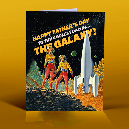 A colorful greeting card featuring an illustration of a man and a woman in space suits on a planet with a rocket ship, celebrating Father's Day with the text 'Happy Father's Day to the Coolest Dad in.