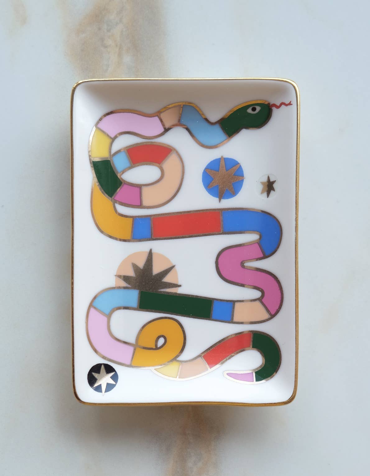 Decorative tray with a colorful snake design on a light background