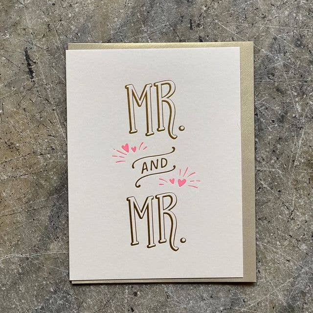 Greeting card with 'MR. AND MR.' text on a textured surface