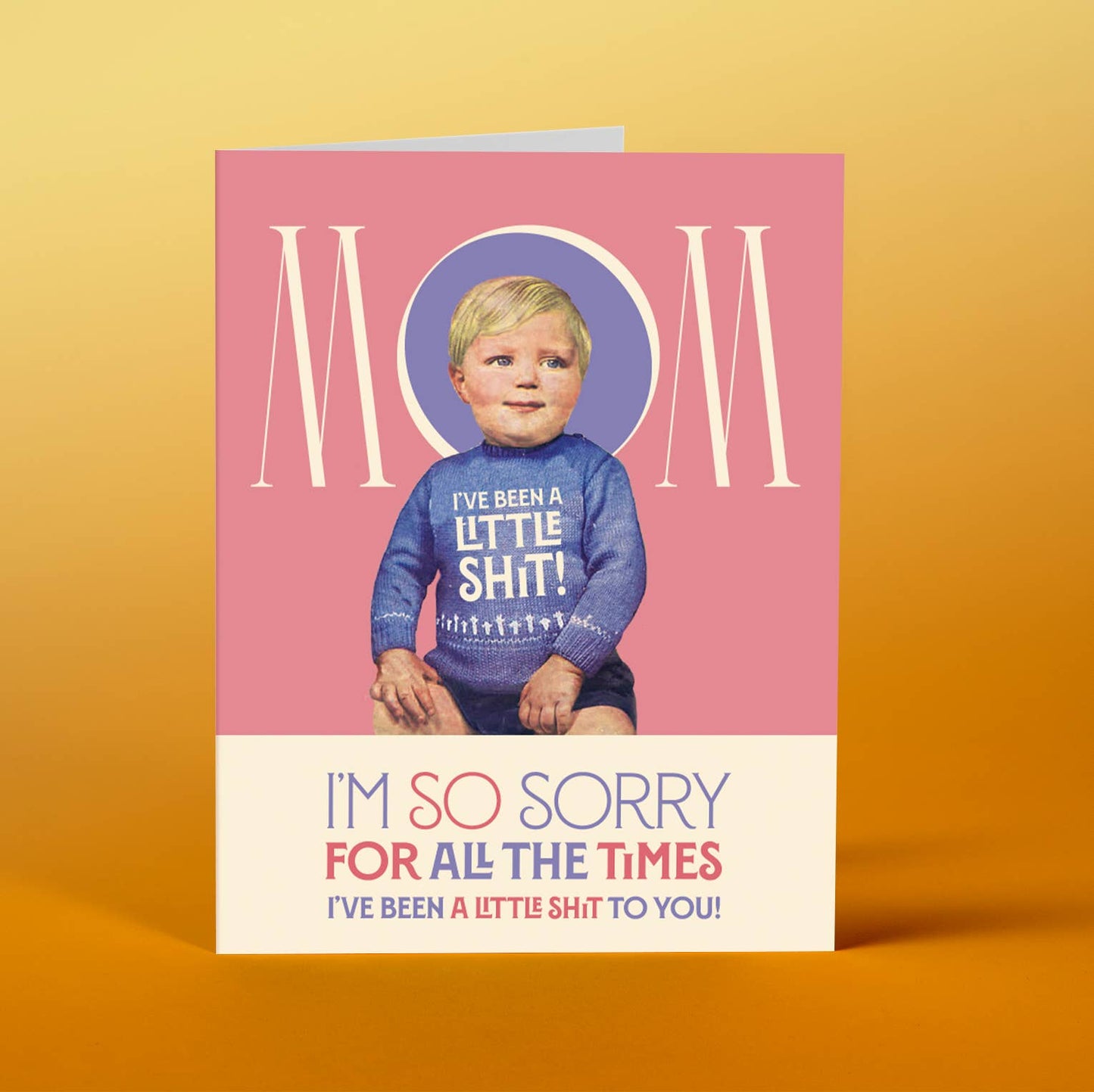 Card with a child wearing a sweater with text, on a pink background with 'Mom' text.