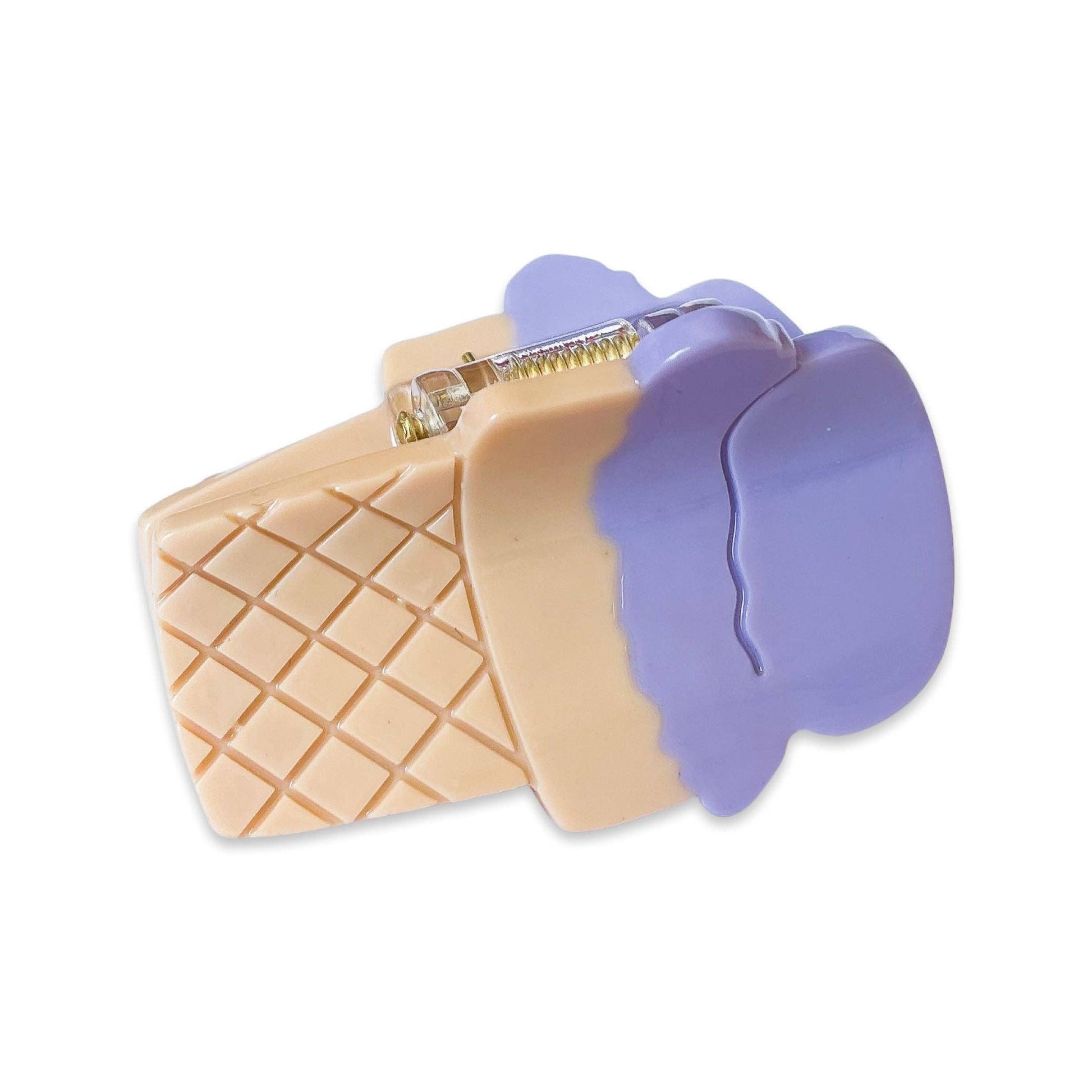 Ice cream cone-shaped cookie cutter with a purple top on a white background