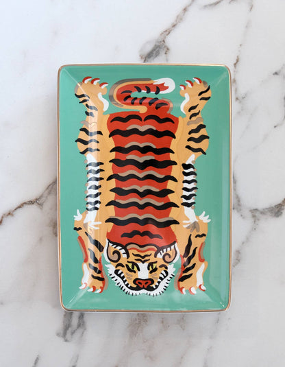 Decorative tray with a tiger design on a marble background