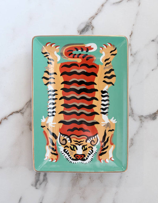 Decorative tray with a tiger design on a marble background