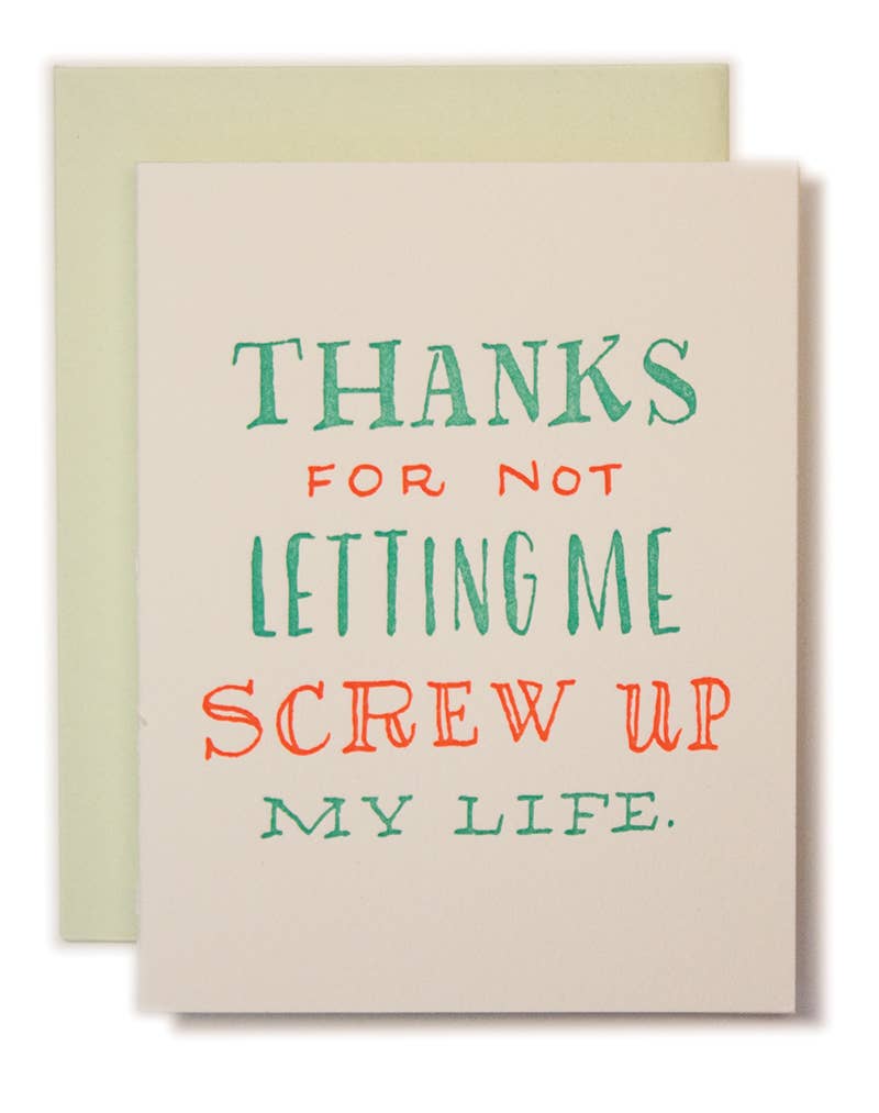 Card with humorous text 'Thanks for not letting me screw up my life' on a beige background with a green envelope.
