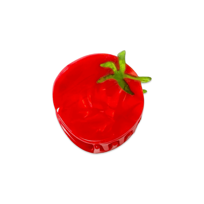 Red tomato-shaped hair claw with green stem on a white background