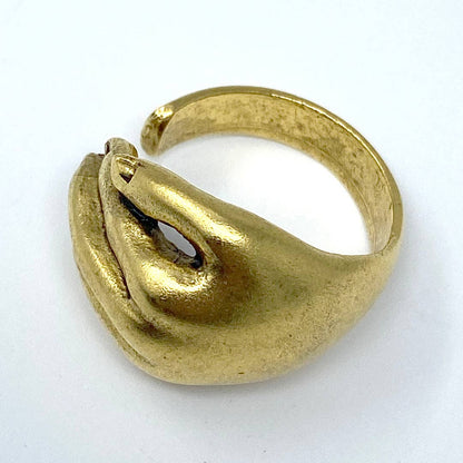 Gold ring with a unique design on a white background
