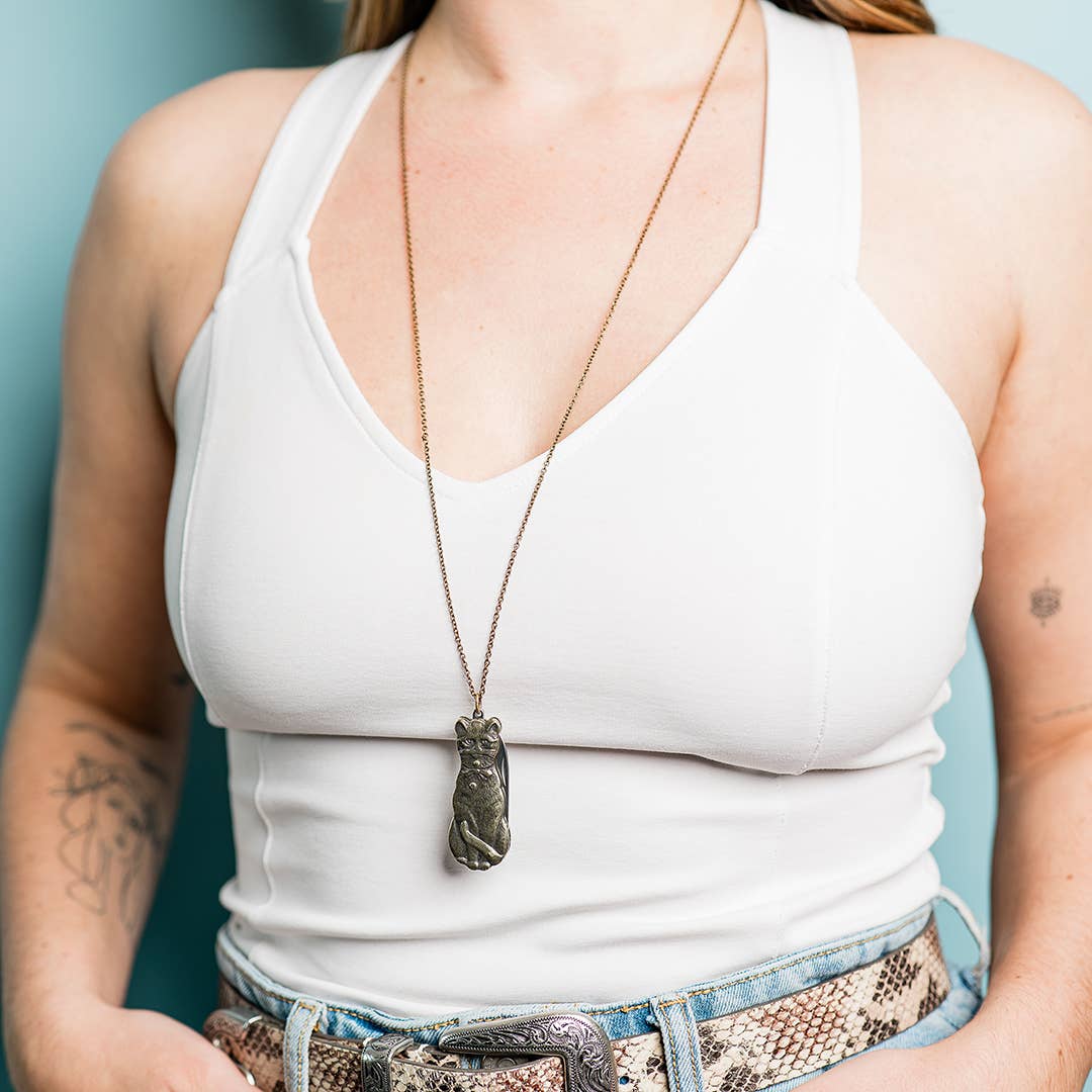 image of person wearing a Metallic cat-shaped knife with a chain 