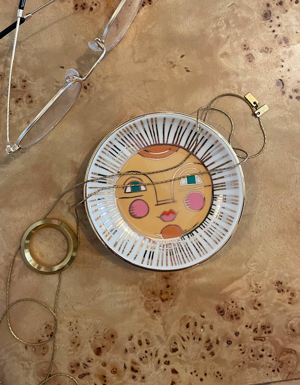 Decorative plate with a face design on a textured surface