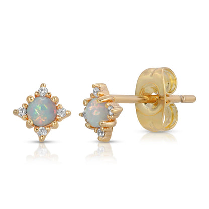 Gold earrings with opal stones on a white background