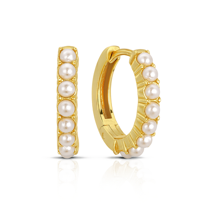 Gold hoop earrings with pearl beads on a white background