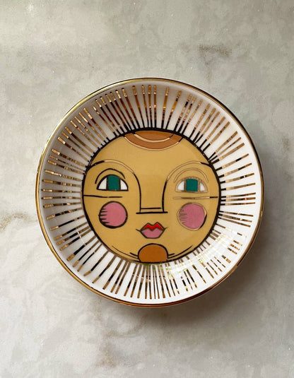 Decorative plate with a face design on a light gray background