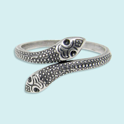 Silver snake-shaped bracelet on a light blue background