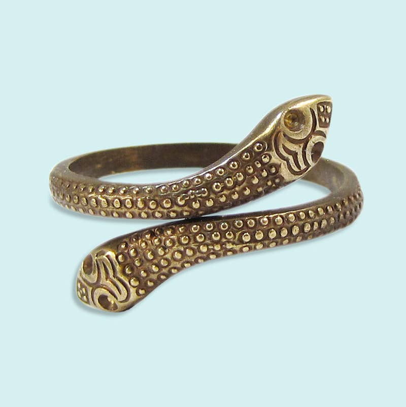 Bronze snake-shaped bracelet on a light blue background