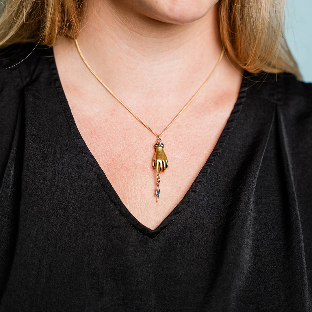 Person wearing a necklace with a unique pendant