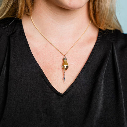 Person wearing a necklace with a unique pendant