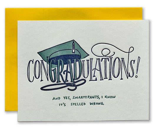 Graduation-themed card with a yellow envelope, featuring a green graduation cap and text.