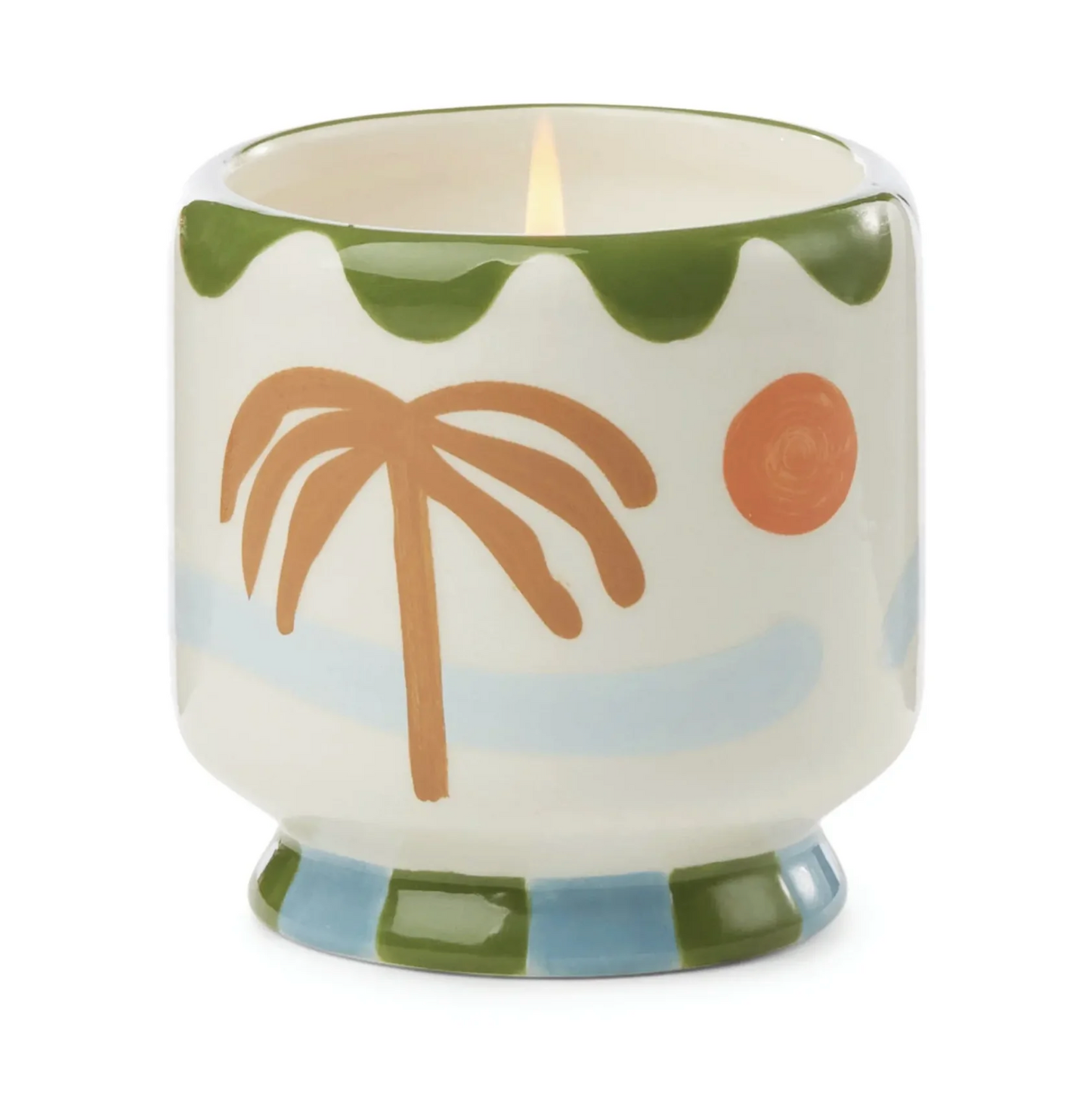 Ceramic candle with palm tree design on a white background