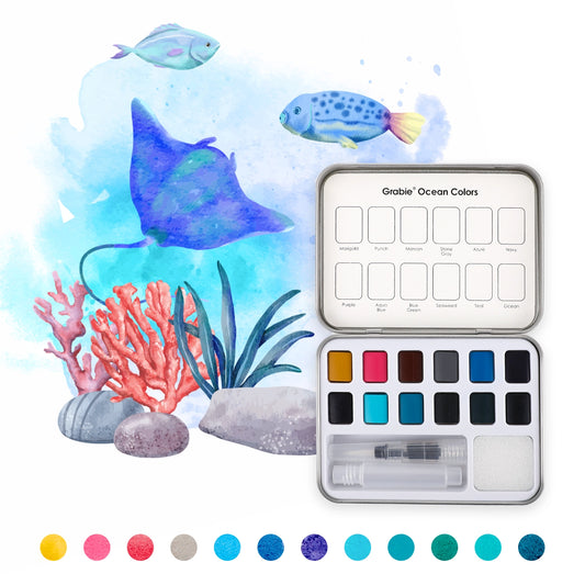 Set of watercolor paints with an ocean-themed illustration featuring fish and coral.