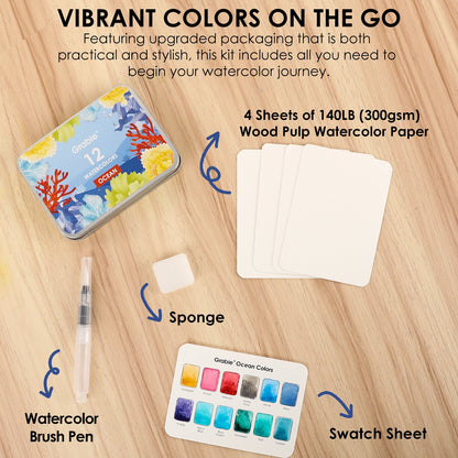 Watercolor art kit with tin, paper, brush pen, sponge, and swatch sheet on a wooden surface.