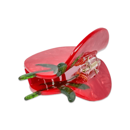 Red plastic tool with green components on a white background