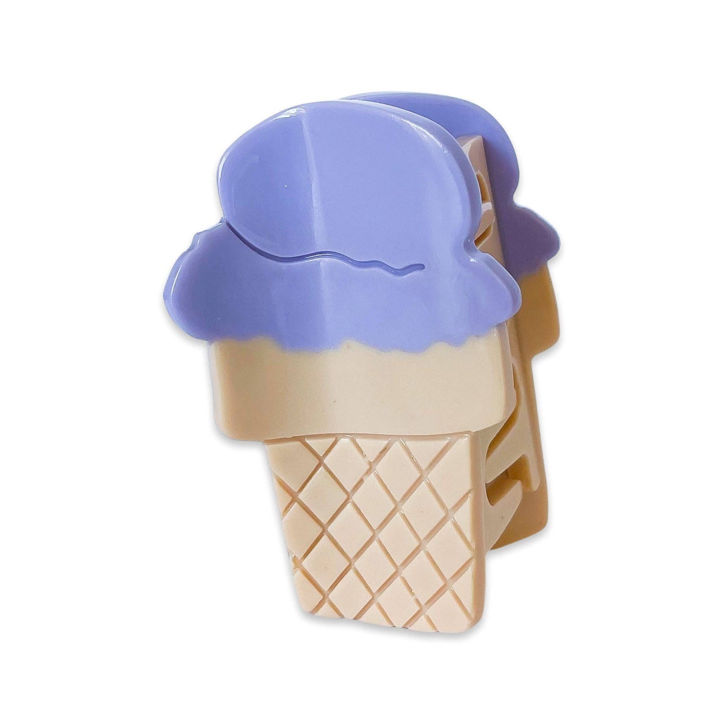 Ice cream cone-shaped cookie cutter with purple top on a white background