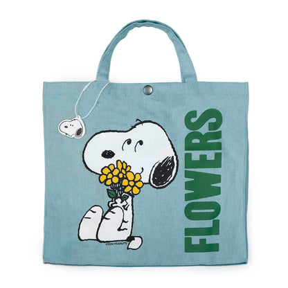 Tote bag with Snoopy holding flowers and 'FLOWERS' text on a light blue background