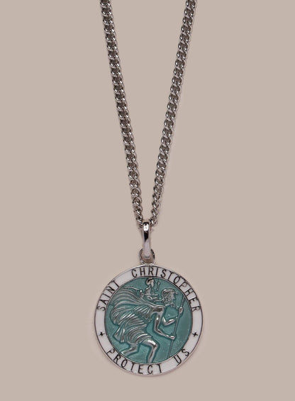 Necklace with a Saint Christopher pendant on a beige background