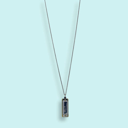 Necklace with a rectangular pendant on a light blue background