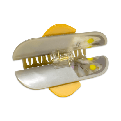 Small metal hole puncher with yellow accents on a white background