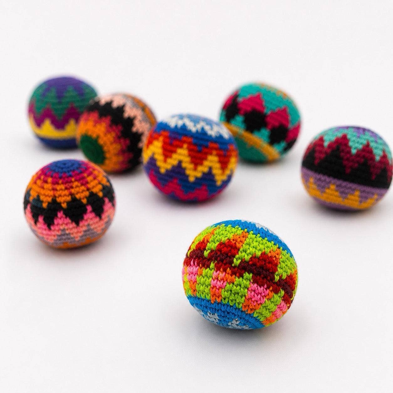 Colorful crocheted balls on a white background