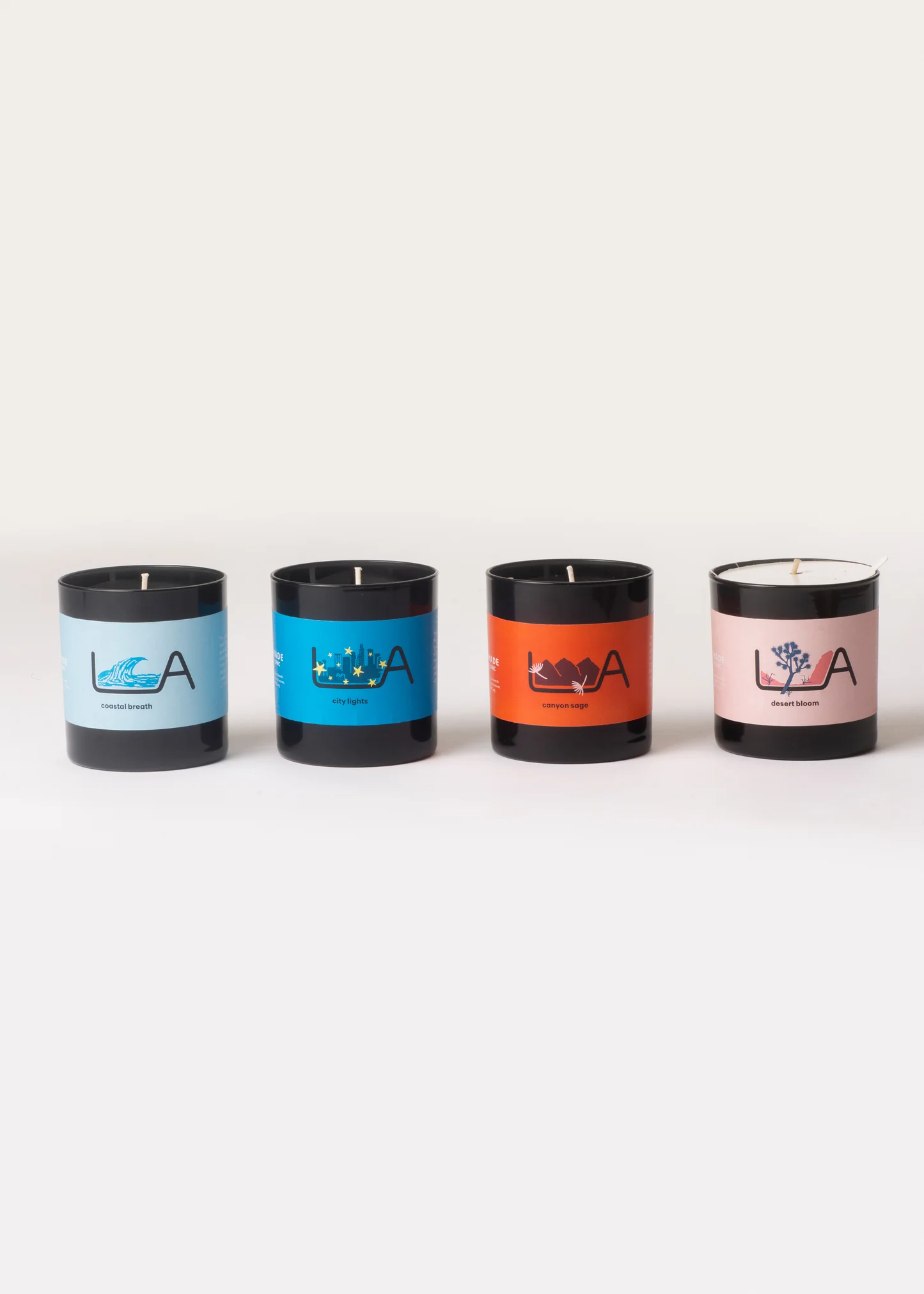 Four candles with different colored lids on a white background
