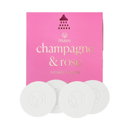 Musee Champagne & Rose shower steamers with pink packaging on a white background