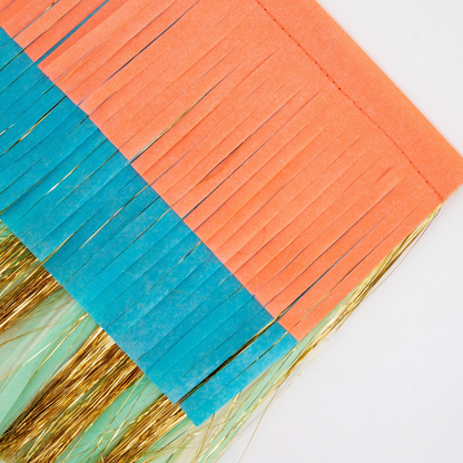 Decorative fringe trim with red, green, and blue colors on a white background