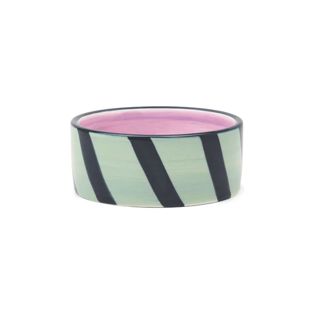 Ceramic bowl with black and white striped design on a white background