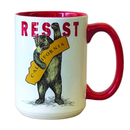 A white ceramic mug with a red interior and red handle, featuring a vintage-style illustration of a bear holding a yellow sign that reads 'CALIFORNIA' beneath the word 'RESIST' in red letters.