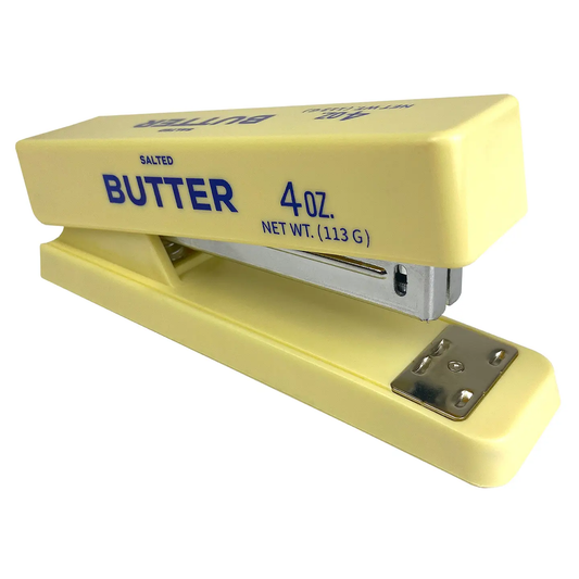 Yellow stapler shaped like a block of butter with blue text on a white background