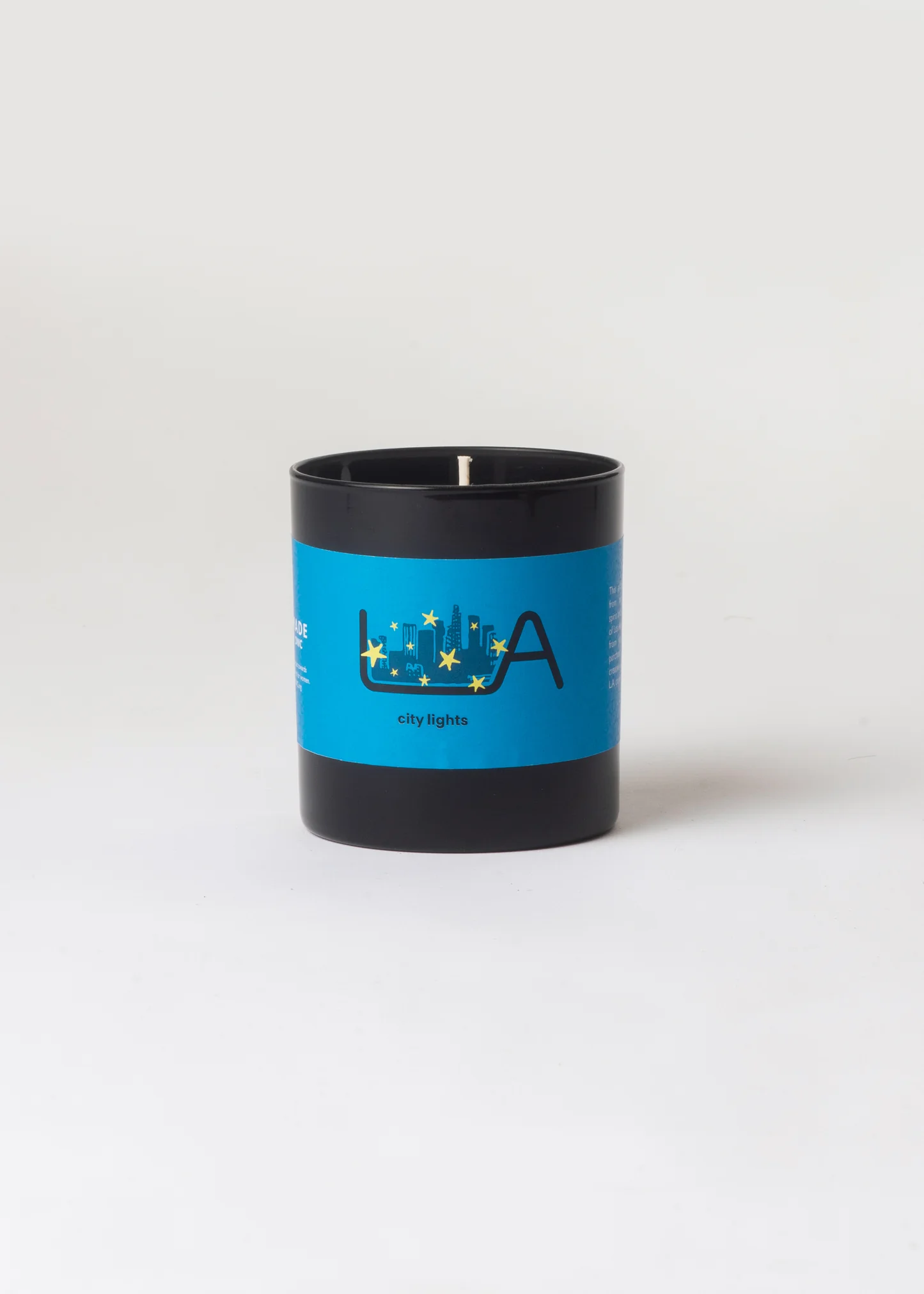 Candle with a blue label featuring a logo on a white background