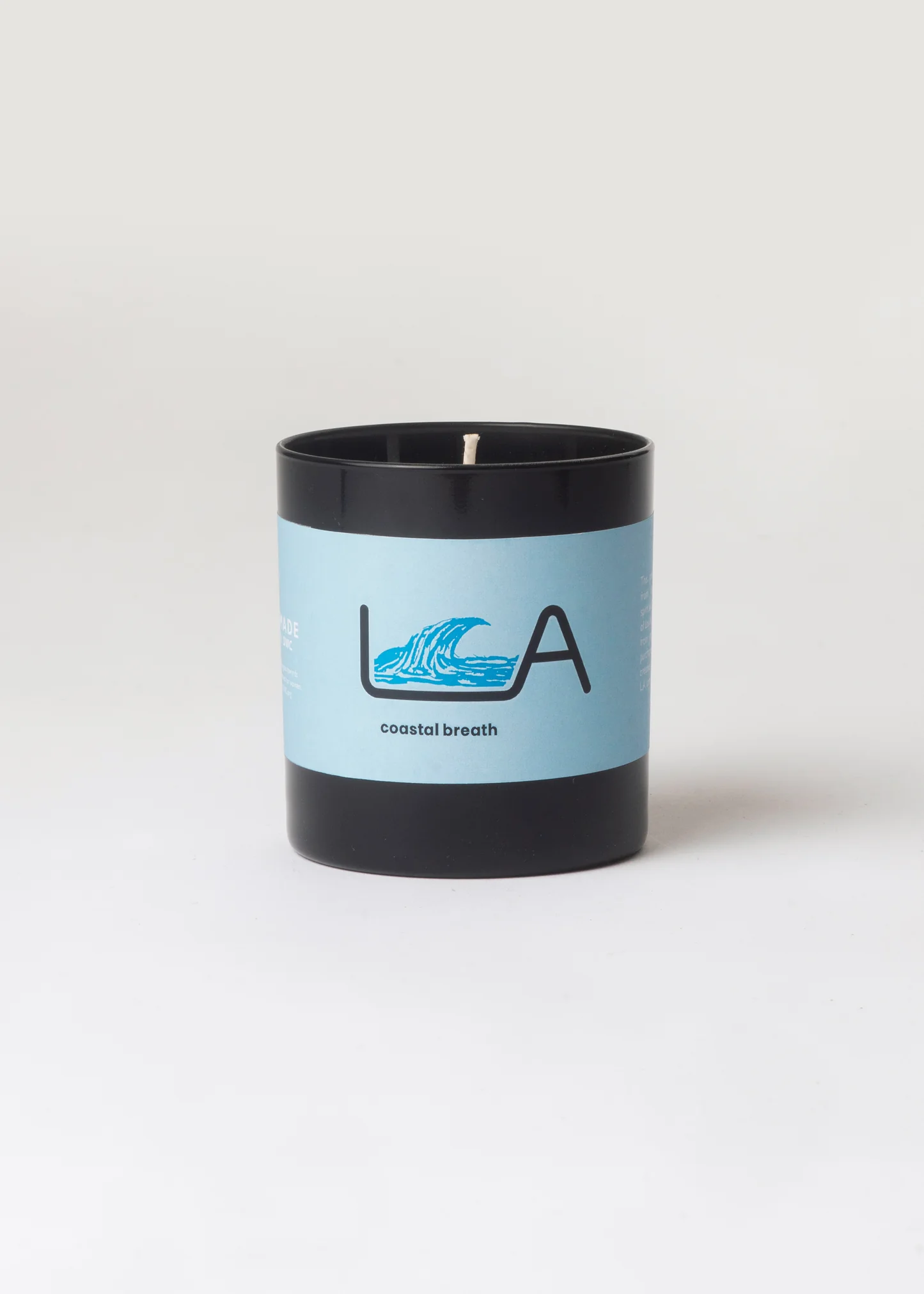 Candle with a blue label featuring a logo on a white background