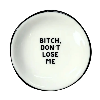 White plate with black text 'Bitch, don't lose me' on a white background