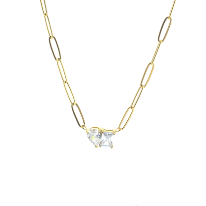 Gold chain necklace with a clear gemstone pendant on a white background