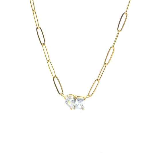 Gold chain necklace with a clear gemstone pendant on a white background